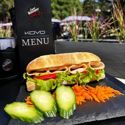 a sandwich on a plate with cucumbers and carrots at Hotel Etropol, Center Etropole in Etropole
