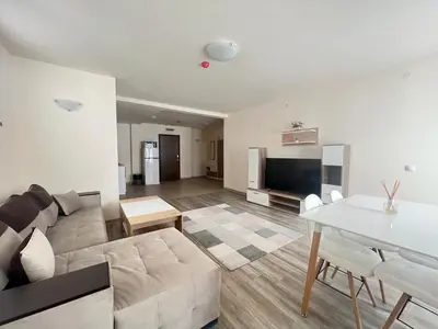 a living room with a couch and a table at Bron's Suite in Pamporovo