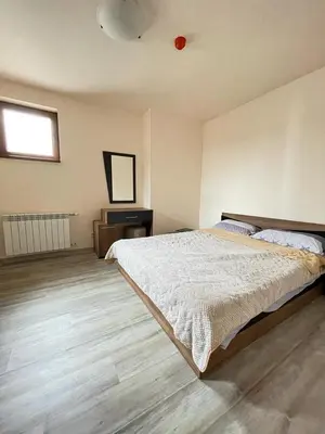 a bedroom with a bed and a television in it at Bron's Suite in Pamporovo