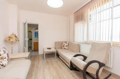a living room with a couch and a window at Апартаменти Viviana in Plovdiv