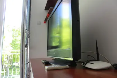 a computer monitor sitting on a wooden table at Апартаменти Viviana in Plovdiv
