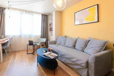 a living room with a couch and a table at Design 1BDR Apartment near City Center in Sofia
