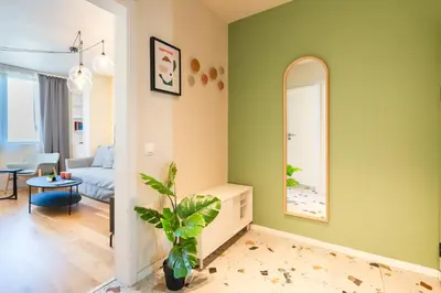 a living room with green walls and a mirror at Design 1BDR Apartment near City Center in Sofia