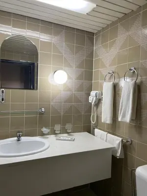 a bathroom with a sink and a mirror at Хотел Ботевград in Botevgrad