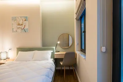 a bedroom with a bed and a desk and a mirror at North 21 - Brand New Modern 1BD Apt in Sofia Center by Flat Mаnager in Sofia