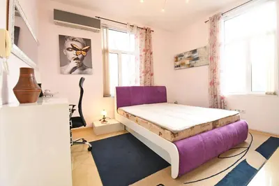 a bedroom with a bed and a purple couch at INB Iconic Spot in Sofia