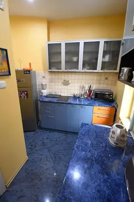 a kitchen with blue marble counter tops and a refrigerator at INB Iconic Spot in Sofia