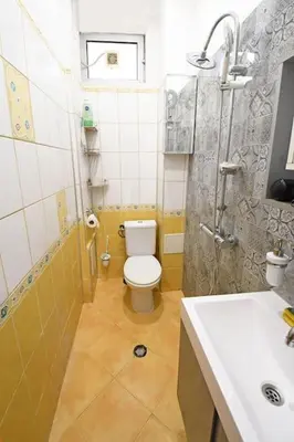 a bathroom with a toilet and a shower and a sink at INB Iconic Spot in Sofia