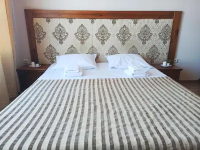 a large bed with two white towels on it at Sunrise View with Free SPA and Bottle of Wine in Cornelia Deluxe Residence, free Parking in Bansko