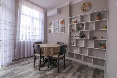 a dining room with a table and chairs and shelves at New 1930s quiet central apartment w/AC - 2 bedroom in Sofia