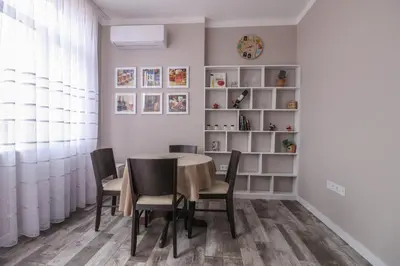 a dining room with a table and chairs and a shelf at New 1930s quiet central apartment w/AC - 2 bedroom in Sofia