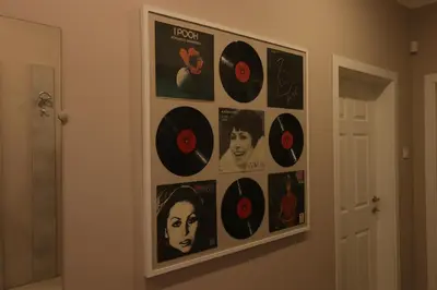 a bunch of records hanging on a wall at New 1930s quiet central apartment w/AC - 2 bedroom in Sofia