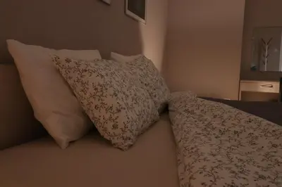 two pillows and a blanket on a bed at New 1930s quiet central apartment w/AC - 2 bedroom in Sofia
