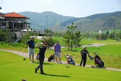 a group of people playing golf on a golf course at Pravets Lake Panorama Apartments in Pravets