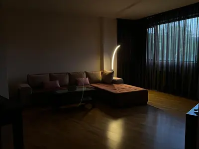 a living room with a couch and a table at Pravets Lake Panorama Apartments in Pravets