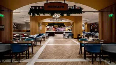 a restaurant with tables and chairs and a bar at Pravets Lake Panorama Apartments in Pravets
