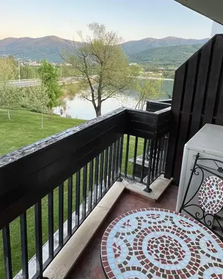a balcony with a view of the water and mountains at Pravets Lake Panorama Apartments in Pravets