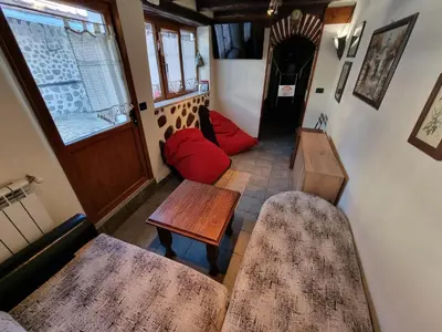 a living room with two tables and a couch at Chalet Garibaldi - Total Chalets in Bansko