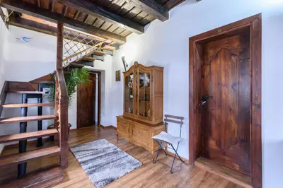a room with a staircase and a wooden door at Chalet Garibaldi - Total Chalets in Bansko