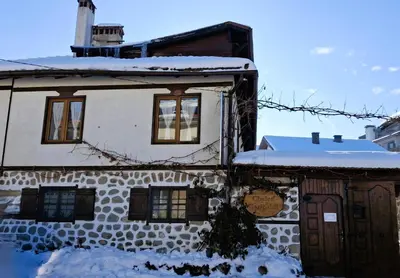 a house with snow on the roof at Chalet Garibaldi - Total Chalets in Bansko