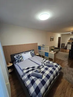 a bedroom with a bed and a living room at IG Apartments Royal Towers 426 in Bansko