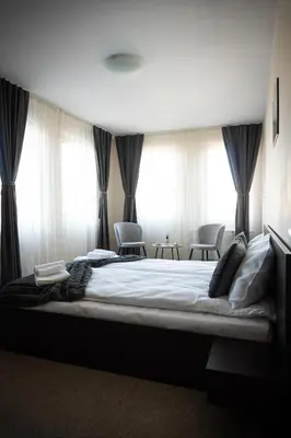 a bedroom with a large bed in front of windows at IG Apartments Royal Towers 426 in Bansko