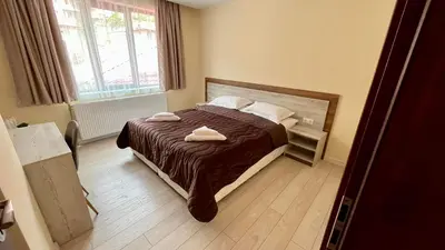 a bedroom with a bed with two towels on it at Къща за гости Михаела in Chepelare