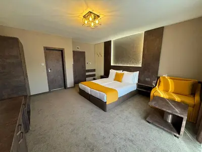 a hotel room with a bed and a television at Стоичковата къща гр. Стрелча in Strelcha