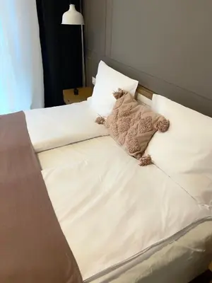 a bed with a teddy bear sitting on top of it at S íRMA Apartment - The Diamond of Sofia in Sofia