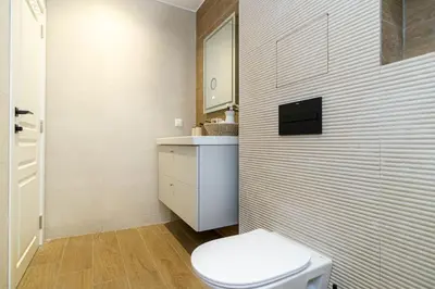 a white bathroom with a toilet and a sink at S íRMA Apartment - The Diamond of Sofia in Sofia