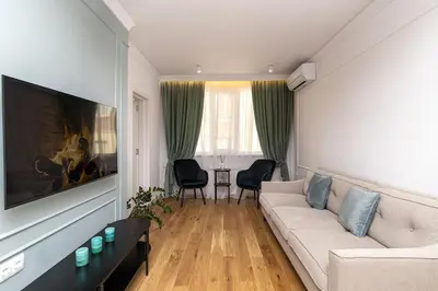 a living room with a couch and a table at S íRMA Apartment - The Diamond of Sofia in Sofia