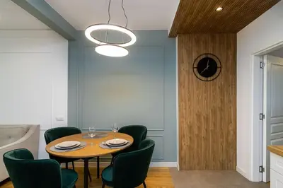 a dining room with a table and green chairs at S íRMA Apartment - The Diamond of Sofia in Sofia