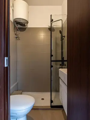 a bathroom with a shower and a toilet and a sink at Skyline Studio - Sofia Center in Sofia