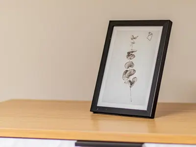 a picture of a flower in a frame on a table at Eagle's Nest - Sofia Central Studio in Sofia