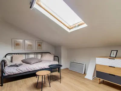 a bedroom with a bed and a skylight at Eagle's Nest - Sofia Central Studio in Sofia