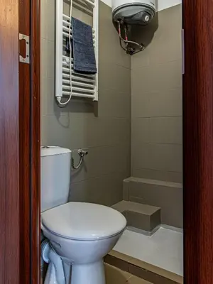 a small bathroom with a toilet and a shower at Lion's Bridge Haven - Sofia Central Studio in Sofia
