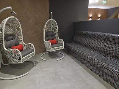 two wicker chairs and a bench in a room at Стаята на Ив in Bansko
