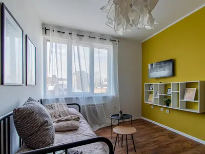 a living room with a couch and a window at Nevsky Loft - Central Sofia Studio in Sofia