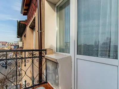 a balcony with a door and a view of a city at Vitosha Loft - Central Sofia Studio in Sofia