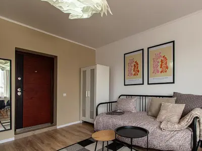a living room with a couch and a table at Boyana Loft - Central Sofia Studio in Sofia
