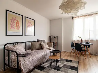 a living room with a couch and a table at Boyana Loft - Central Sofia Studio in Sofia