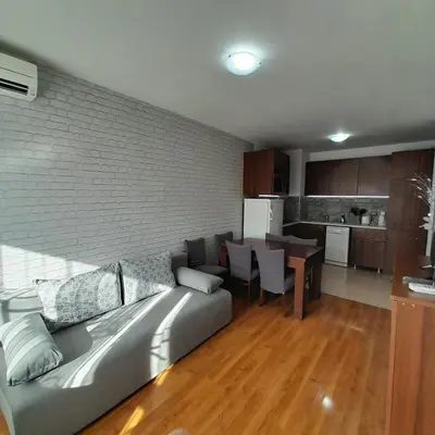a living room with a couch and a kitchen at lux Apartament L201 in Bansko