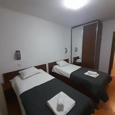 a hotel room with two beds and a mirror at lux Apartament L201 in Bansko