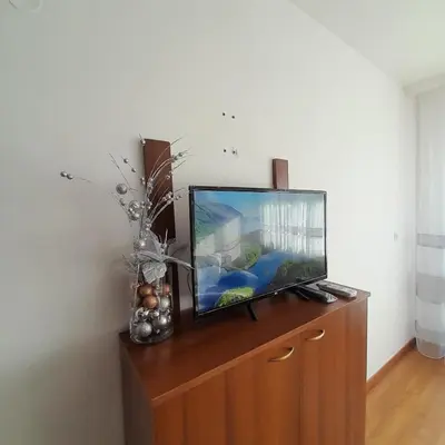 a flat screen tv sitting on top of a wooden cabinet at lux Apartament L201 in Bansko