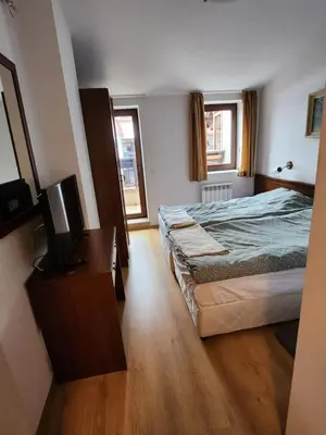 a bedroom with a bed and a television in it at Mountain paradise apartment in Bansko