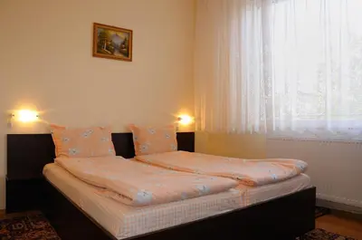 a small bed in a room with a window at Sakutski House in Hisarya
