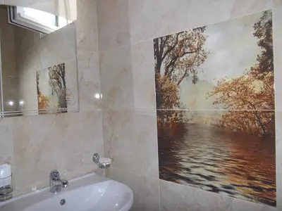 a bathroom with a sink and a painting on the wall at Sakutski House in Hisarya