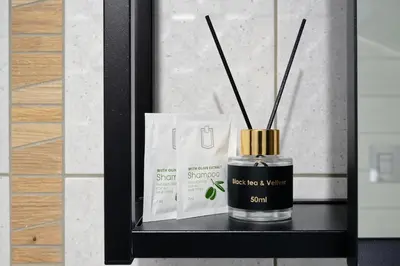 a bottle of sril perfume sitting on a shelf at Sakutski House in Hisarya