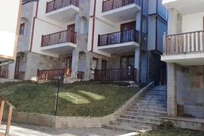 an apartment building with stairs in front of it at Апартамент 9 in Pamporovo
