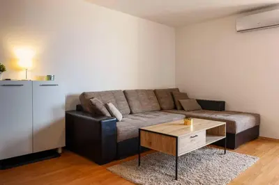 a living room with a couch and a coffee table at Bansko Ski & Relax Apartment in Bansko